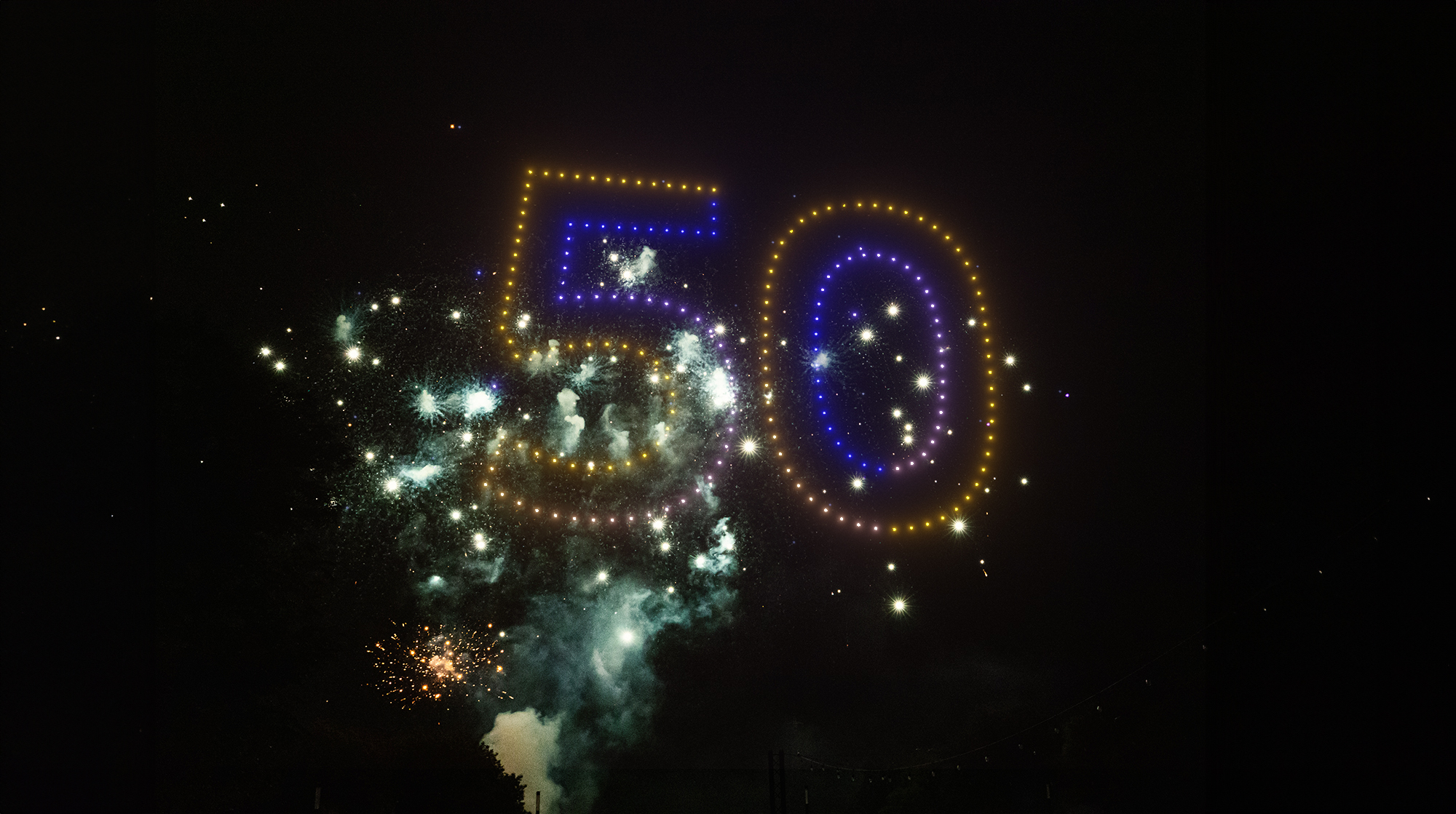 corporate logo drone show 50 years with pyrotechnics
